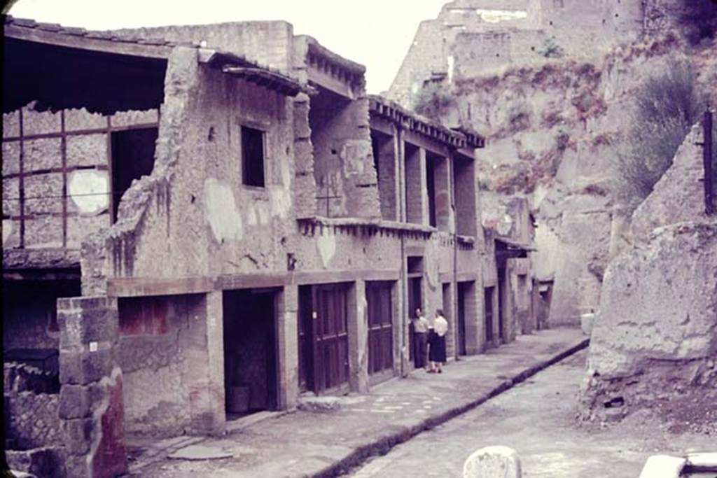 Ins. V, north side. 1955. Looking west along Ins V. on Decumanus Maximus, Wilhelmina is just going into V.15, the House of the Bicentenary. Photo by Stanley A. Jashemski.
Source: The Wilhelmina and Stanley A. Jashemski archive in the University of Maryland Library, Special Collections (See collection page) and made available under the Creative Commons Attribution-Non Commercial License v.4. See Licence and use details. J55f0472.